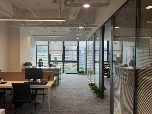 office with furniture but no people. Lights on, no one in sight. 